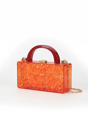 Orange transparent handbag with a gold chain on a white background