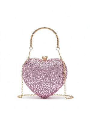 Pink heart-shaped clutch bag with gold chain on a white background