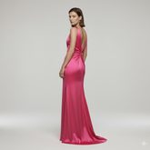 Pink evening gown on a model against a plain background