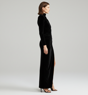 Woman wearing a black velvet dress on a white background