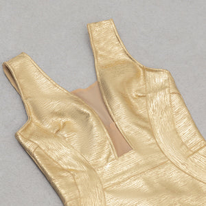 Gold metallic dress bodice on a gray background