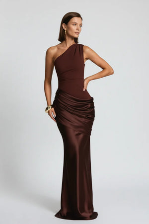 Woman wearing a brown one-shoulder evening gown on a white background