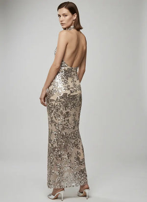 Woman wearing a sparkly evening gown with a white background