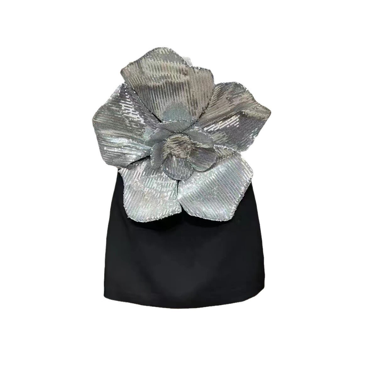 Black top with a large silver sequin flower on a white background