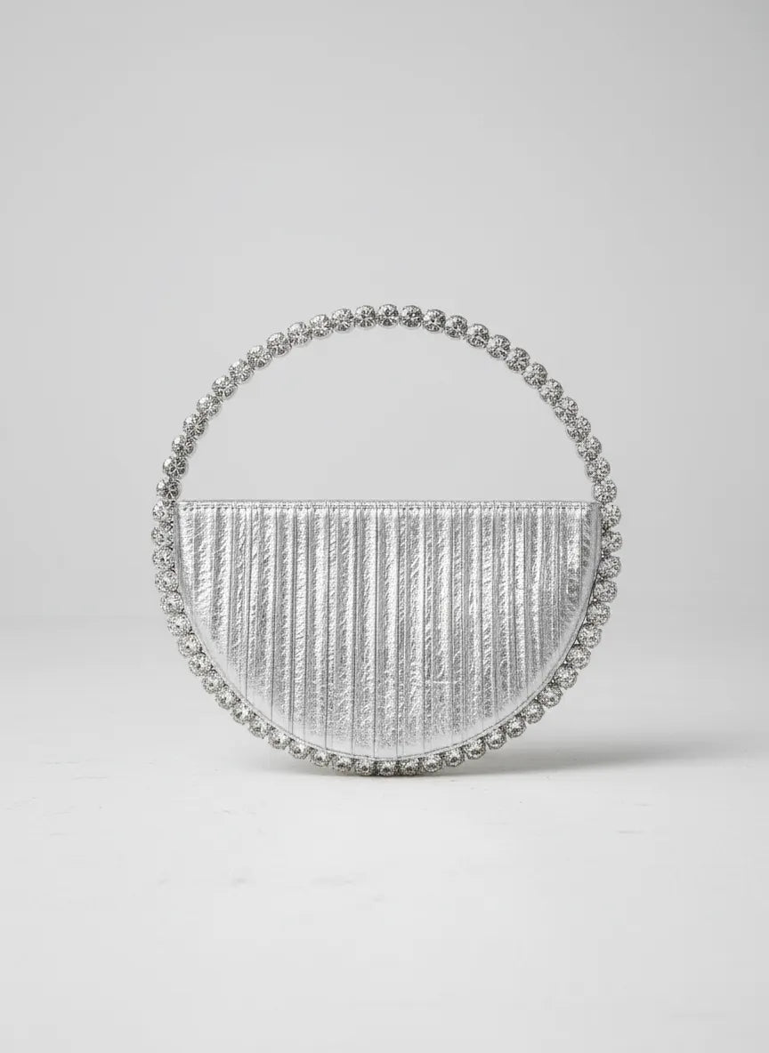 Silver handbag with beaded details on a light gray background