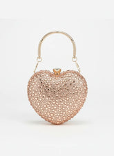 Heart-shaped clutch bag with rose gold finish on a white background