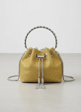 Yellow woven handbag with silver accents on a light gray background