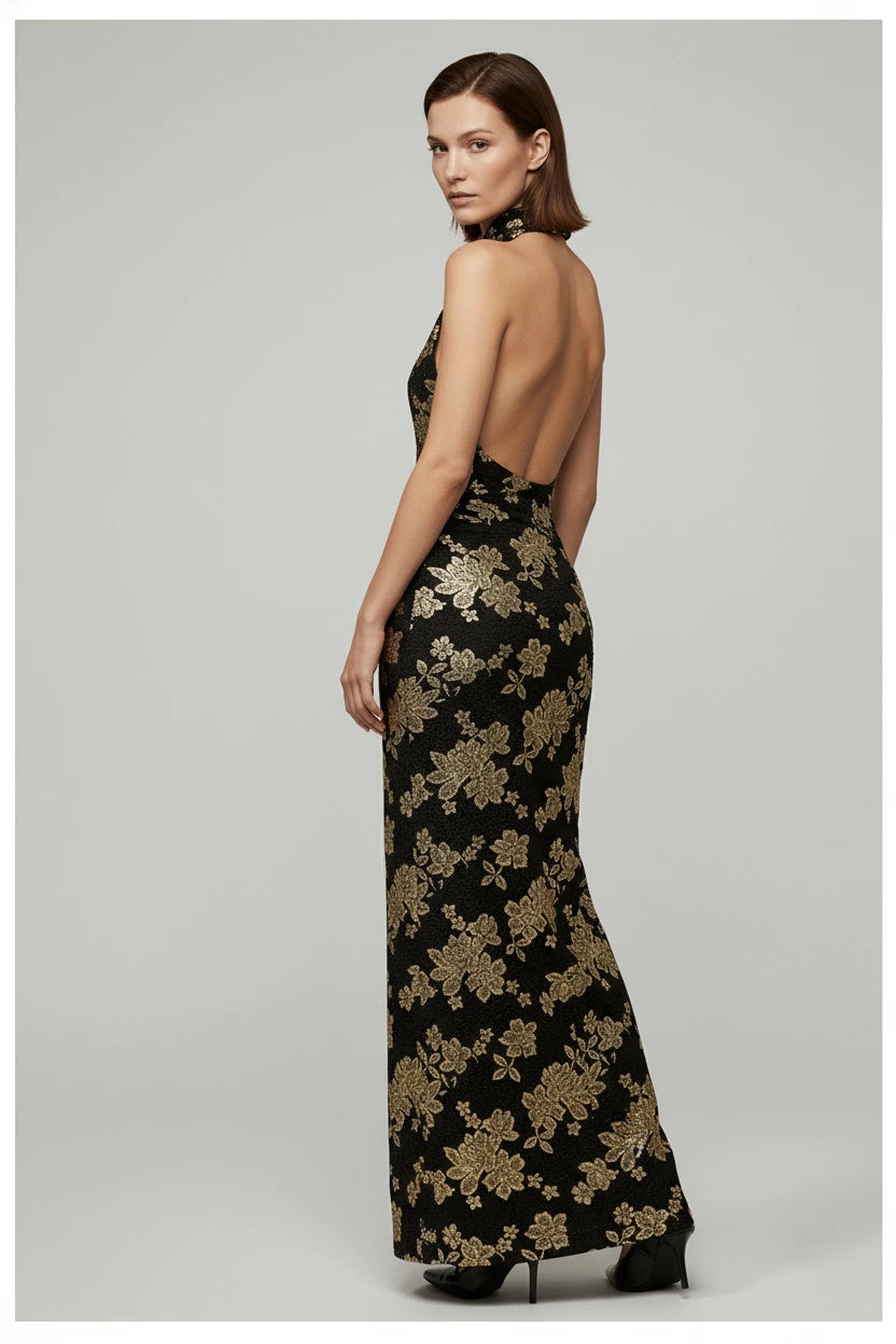 Woman wearing a black floral evening gown on a gray background