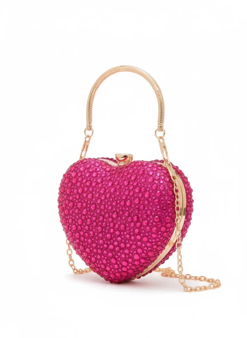 Pink heart-shaped clutch bag with gold chain on a white background