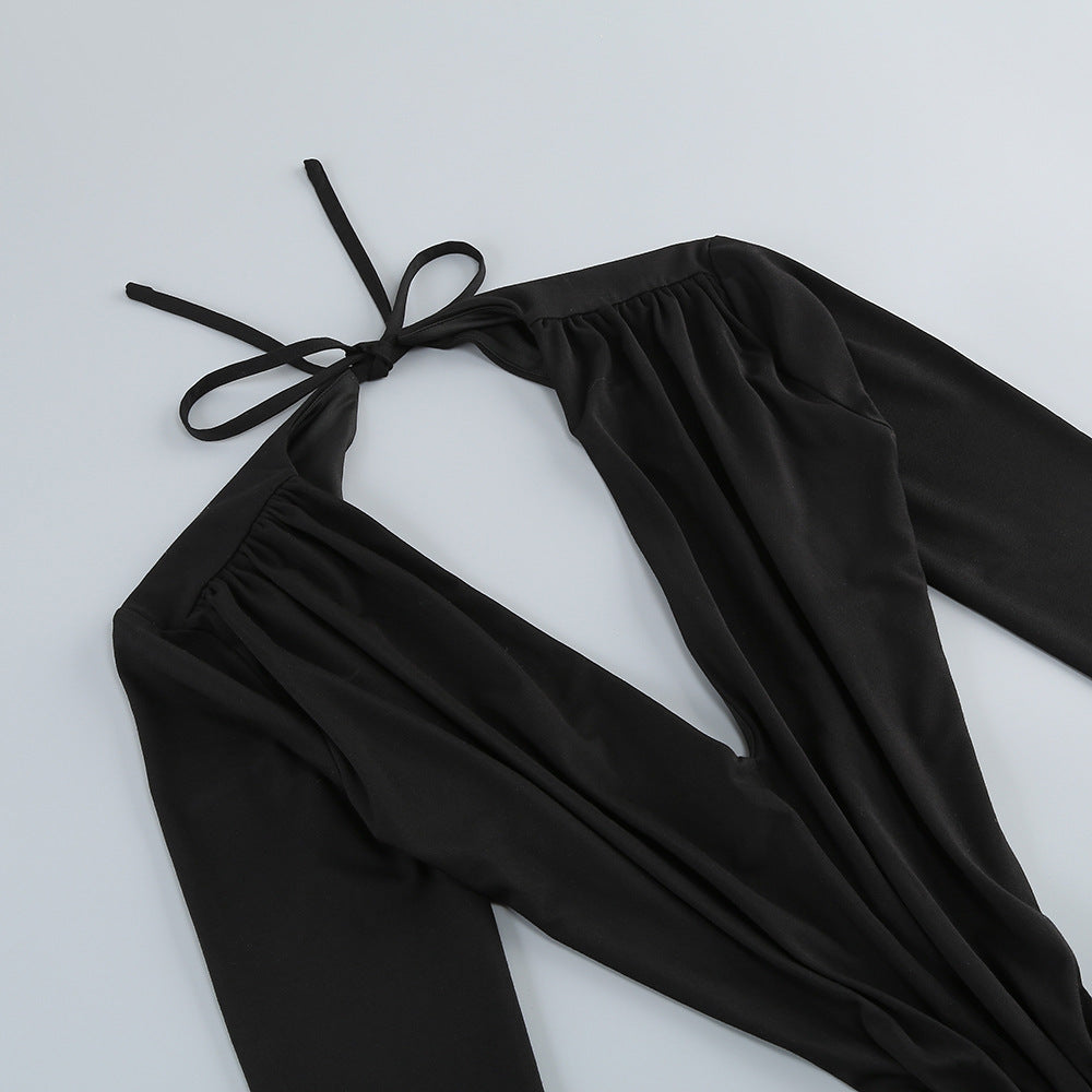 Black halter top with long sleeves on a light gray background