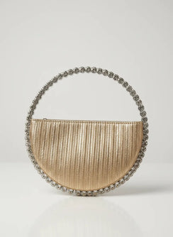 Gold handbag with decorative handle on a light gray background