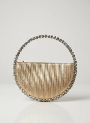 Gold handbag with decorative handle on a light gray background