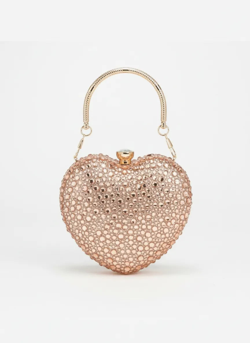 Heart-shaped clutch bag with rose gold finish on a white background