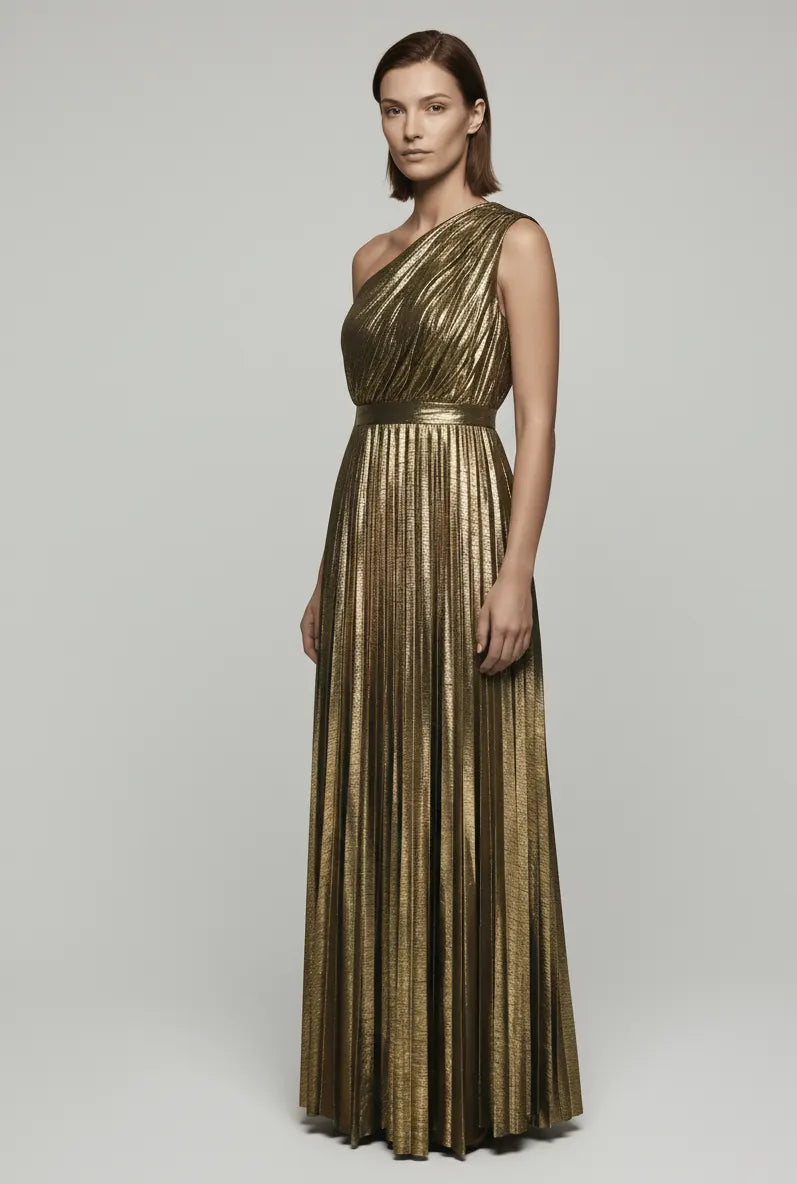 Woman wearing a gold one-shoulder dress on a plain background