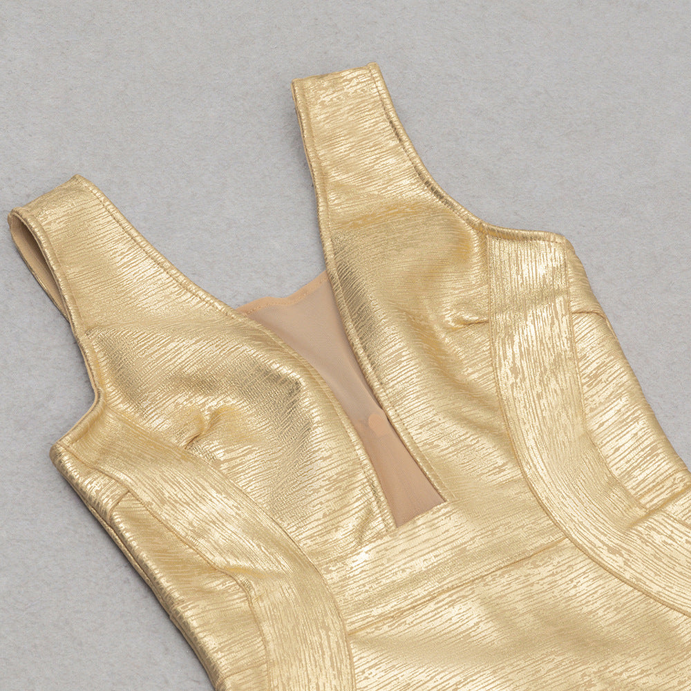 Gold metallic dress bodice on a gray background