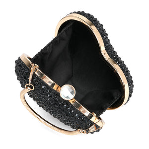 Black handbag with gold accents and a pearl-like clasp on a white background