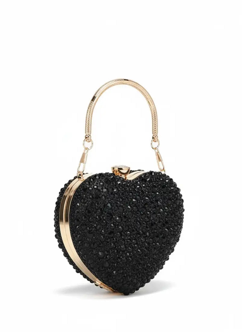 Black heart-shaped clutch bag with gold accents on a white background