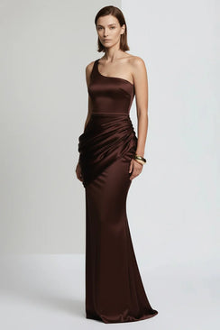 Woman wearing a brown one-shoulder evening gown on a white background
