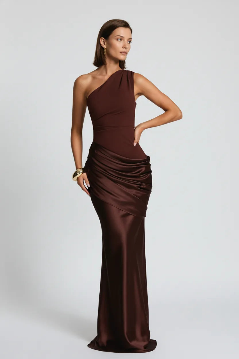 Woman wearing a brown one-shoulder evening gown on a white background