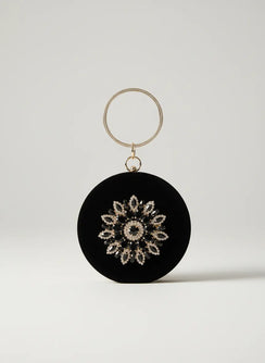 Black circular ornament with decorative pattern on a white background