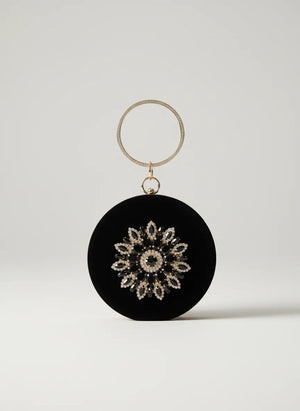 Black circular ornament with decorative pattern on a white background