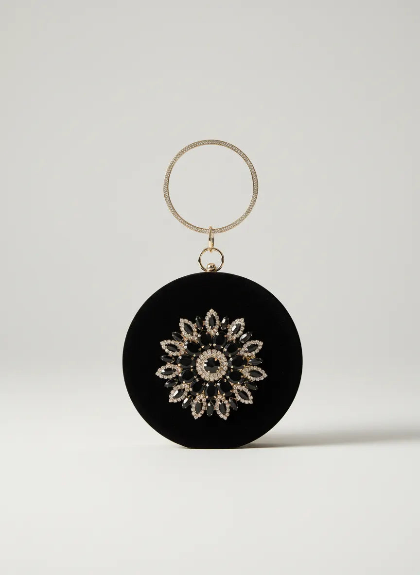 Black circular ornament with decorative pattern on a white background