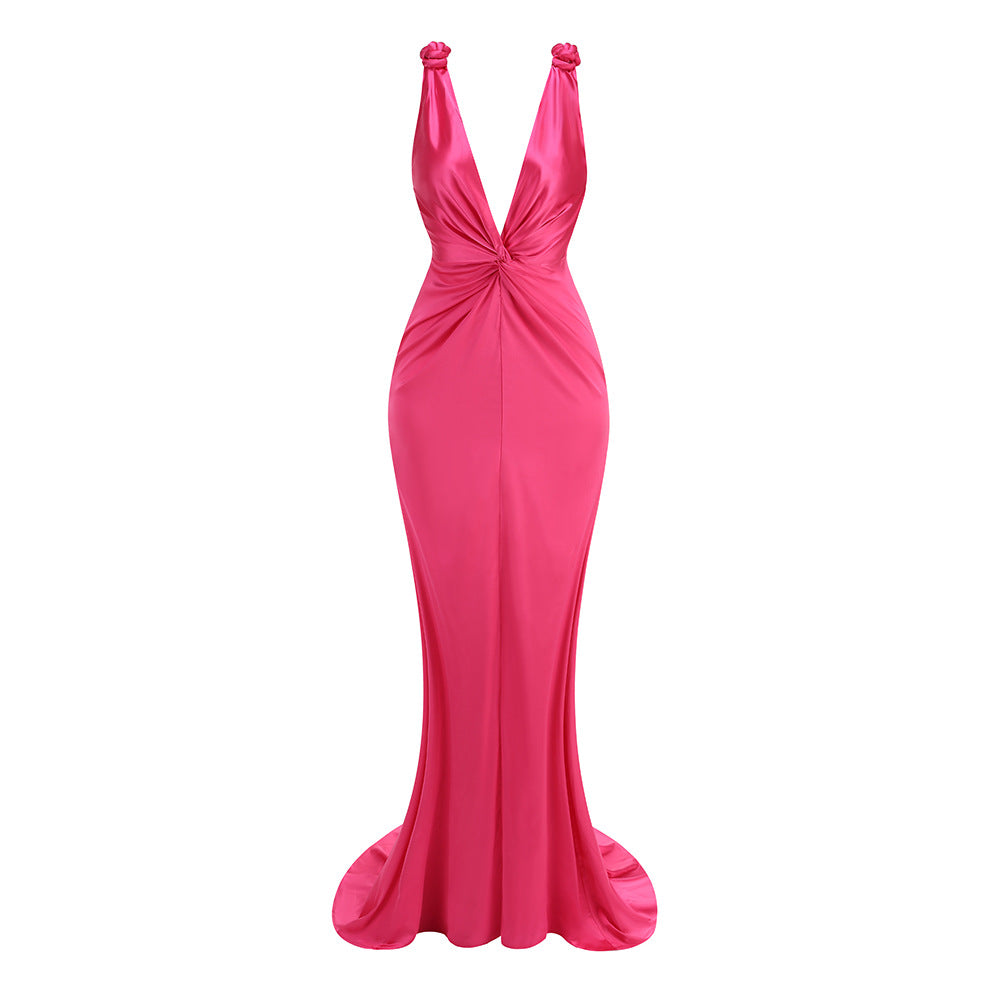 Pink evening gown with a deep neckline on a white background
