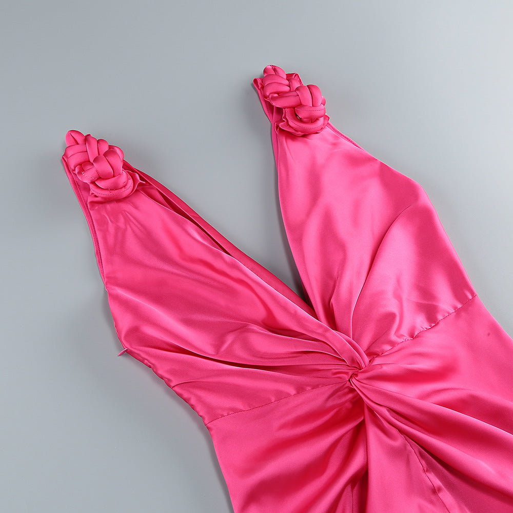 Pink satin dress with floral details on a gray background