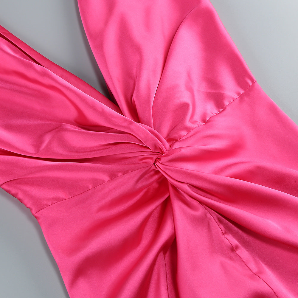 Close-up of a pink satin bow on a gray background
