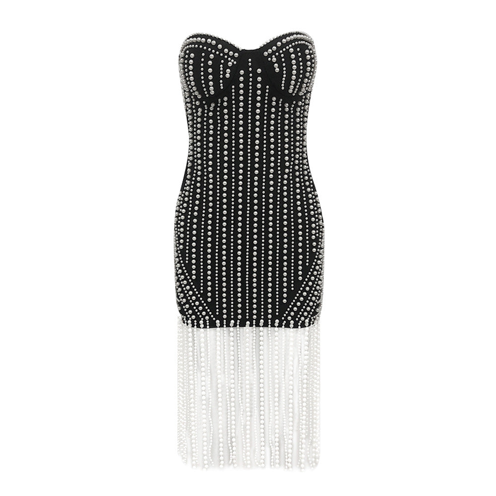 Black strapless dress with white fringe details on a white background