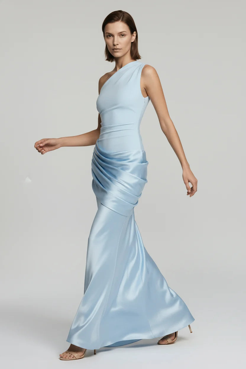 Woman wearing a light blue one-shoulder gown on a white background