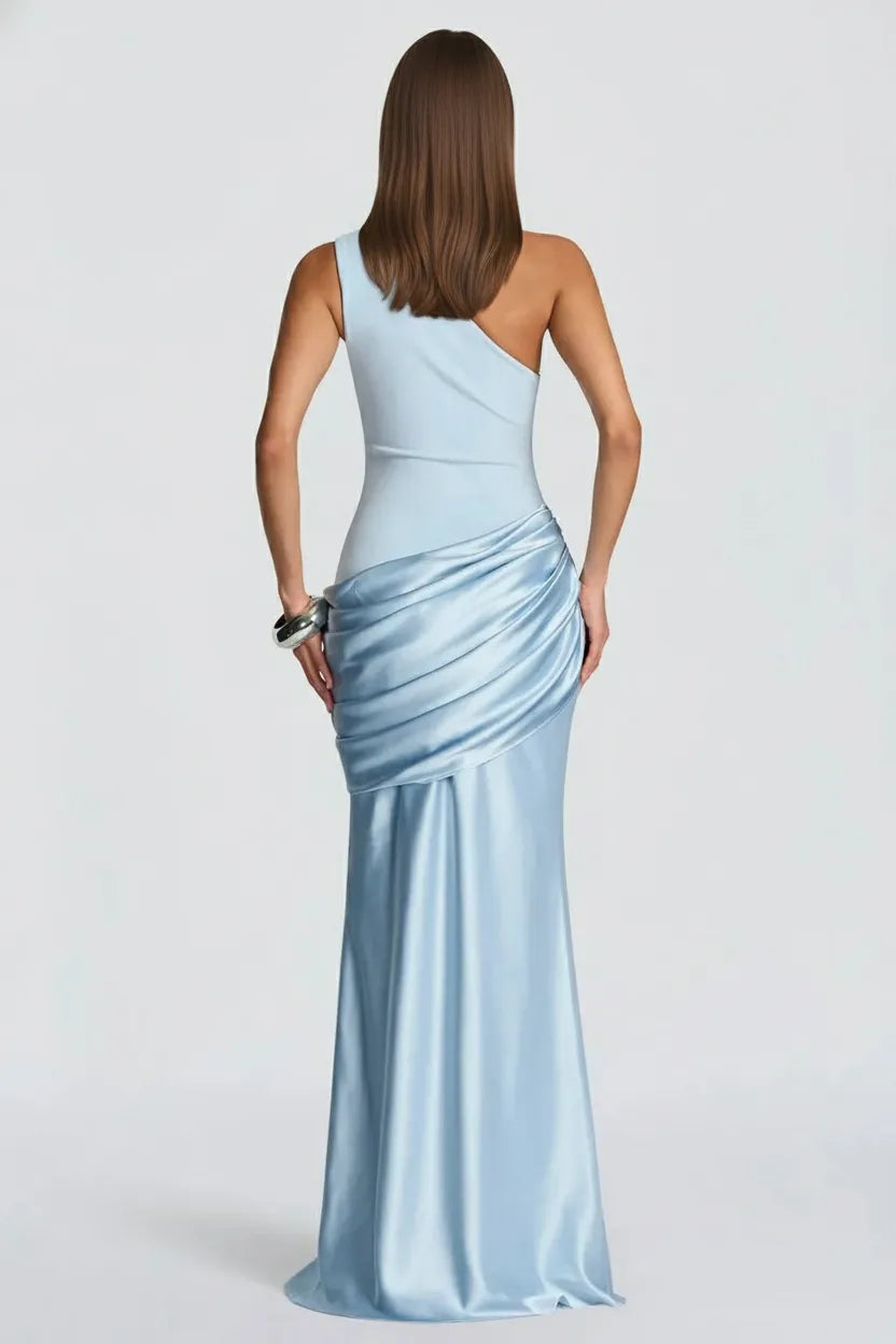 Woman wearing a light blue one-shoulder evening gown on a white background