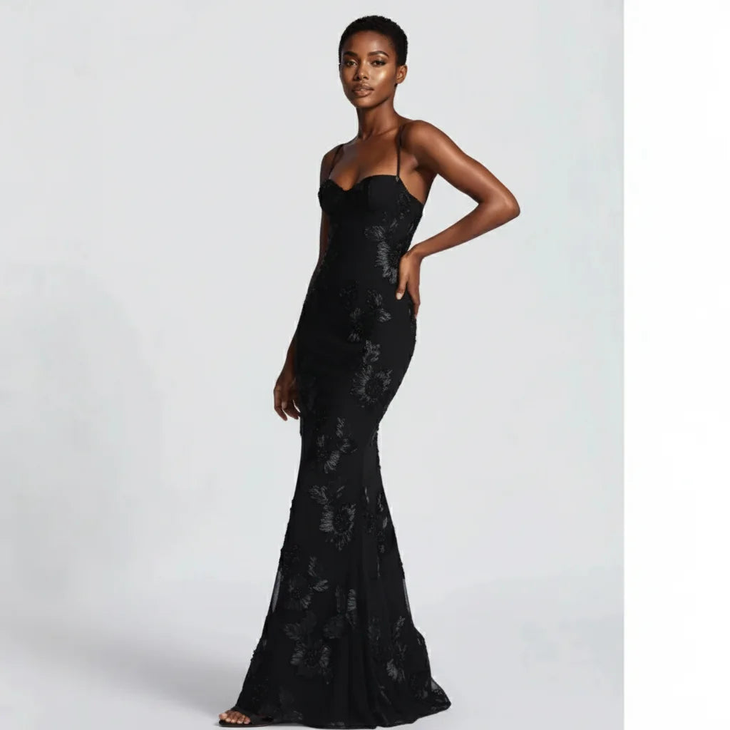 Woman wearing a black evening gown on a white background