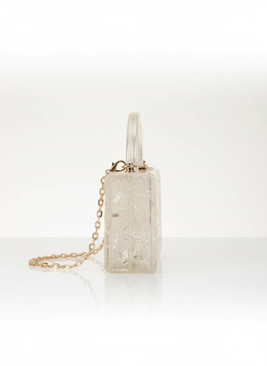 Crystal handbag with gold chain on a white background