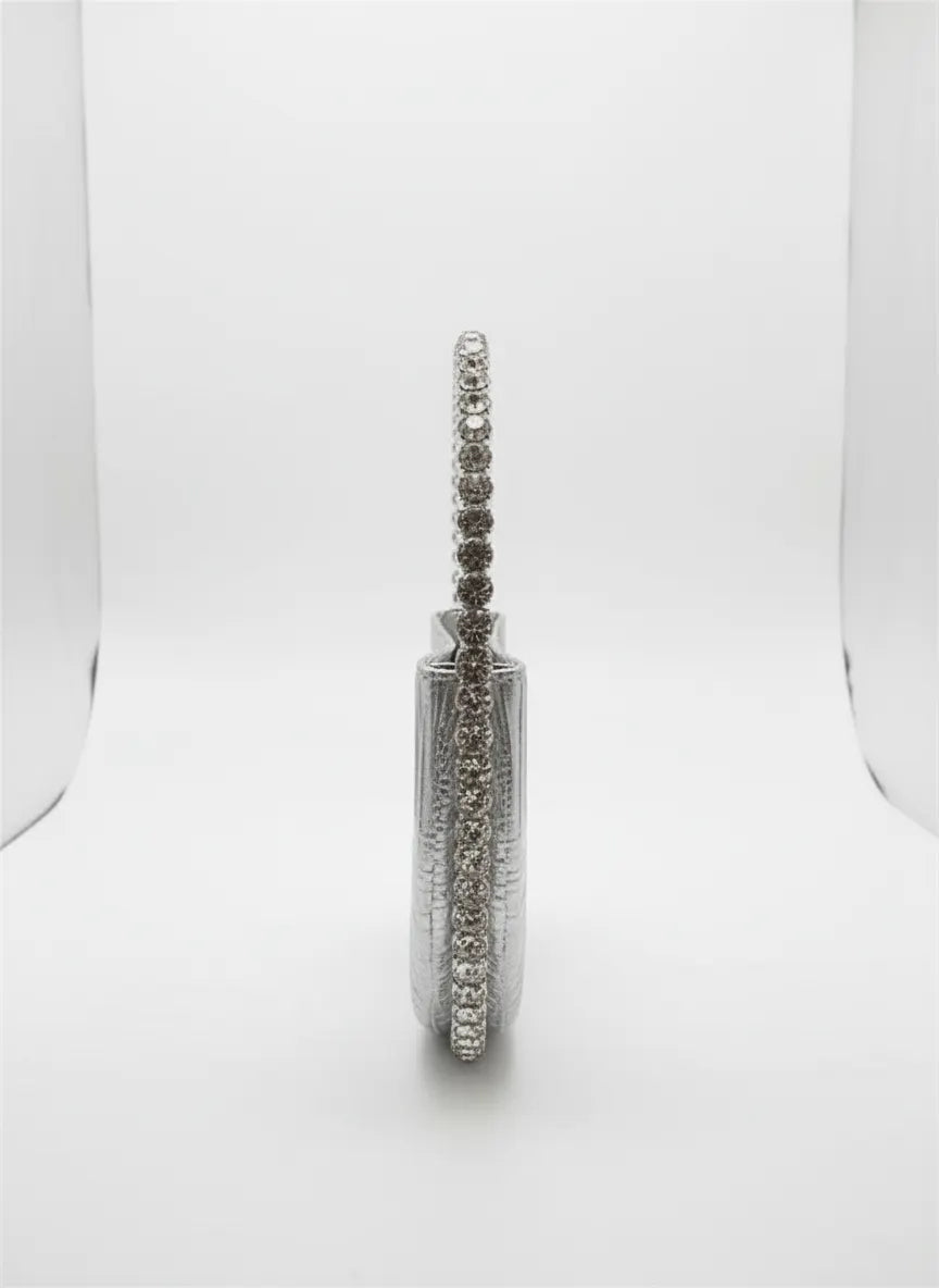 Silver earring with clear stones on a white background