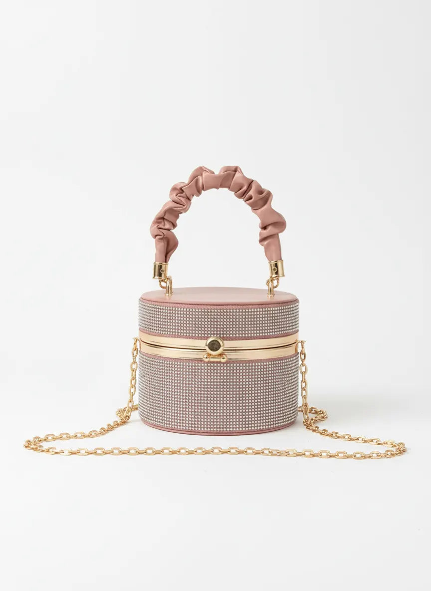 Pink handbag with chain detail on a white background