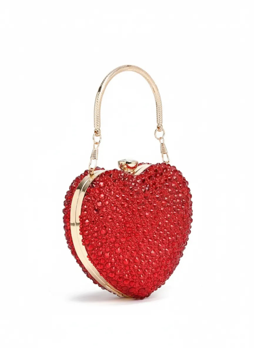 Red heart-shaped clutch bag with gold accents on a white background