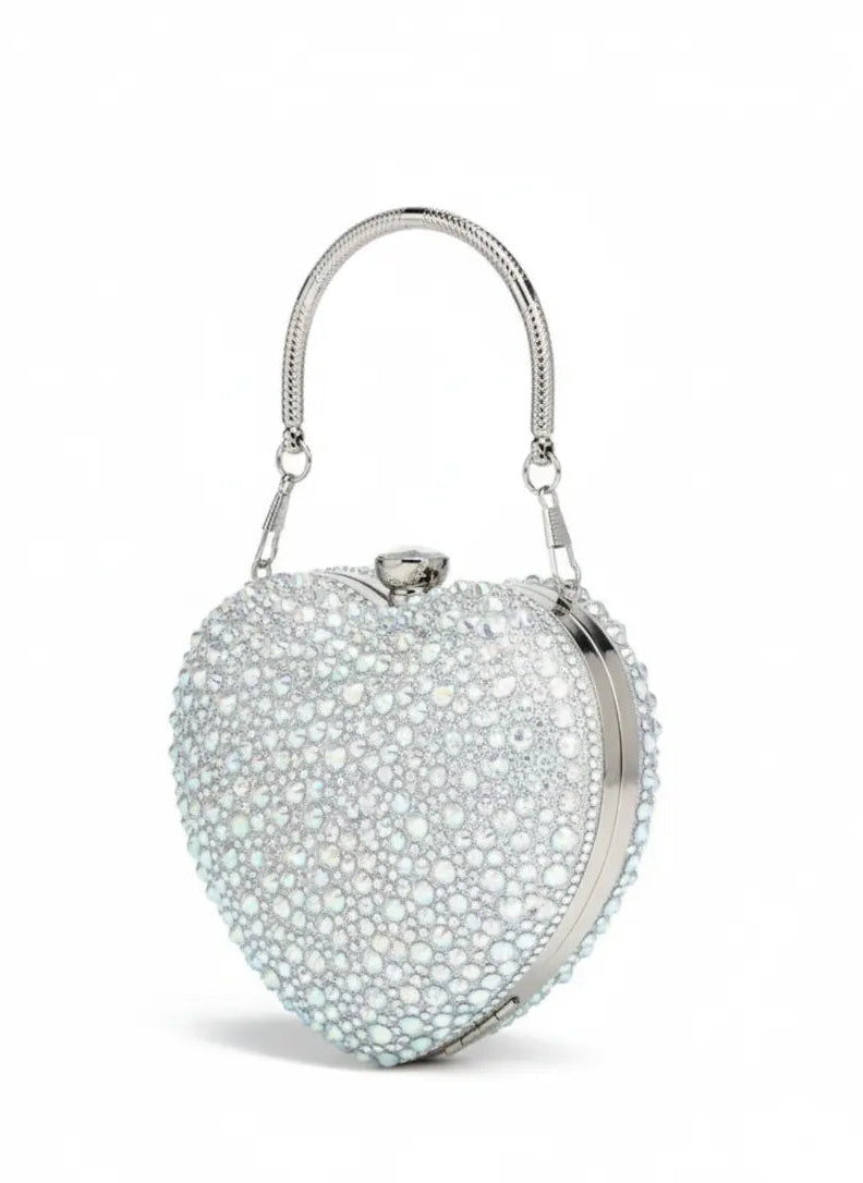 Heart-shaped handbag with pearl-like embellishments on a white background