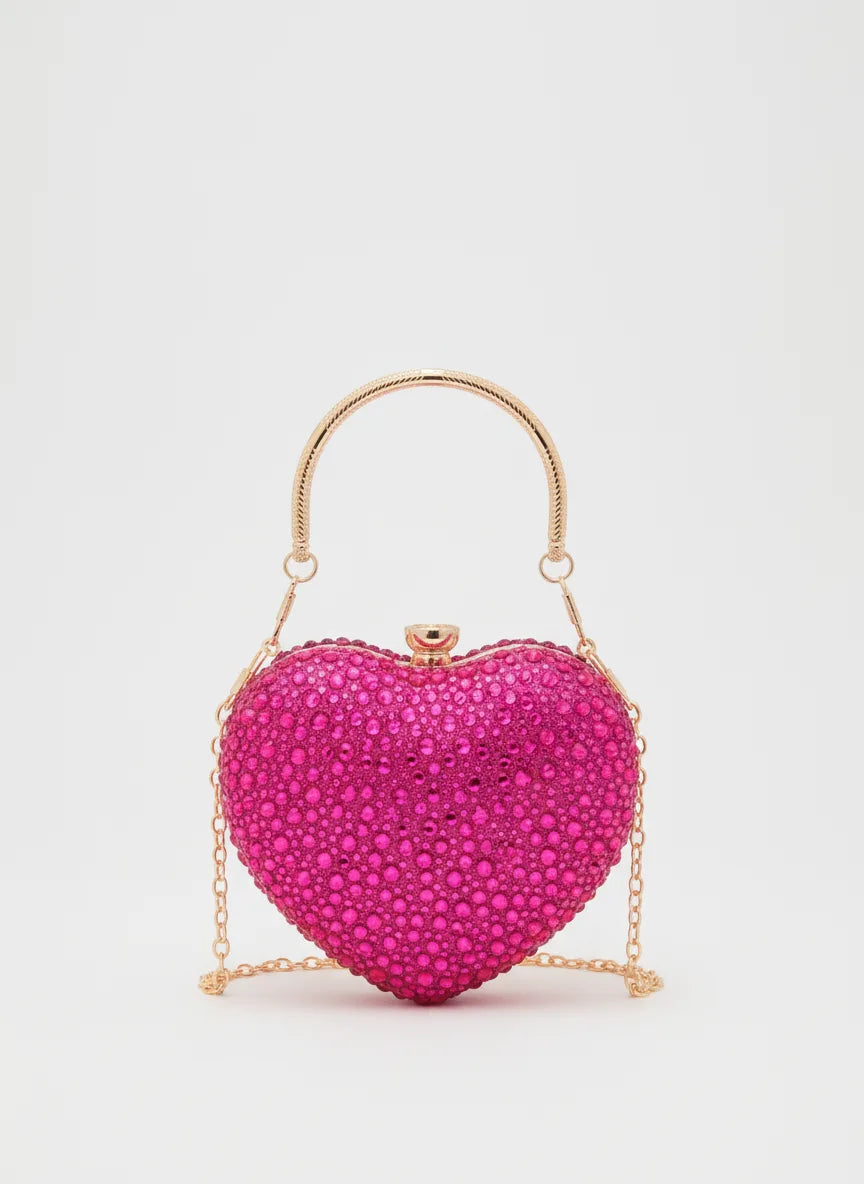 Pink heart-shaped handbag with gold chain handle on a light gray background
