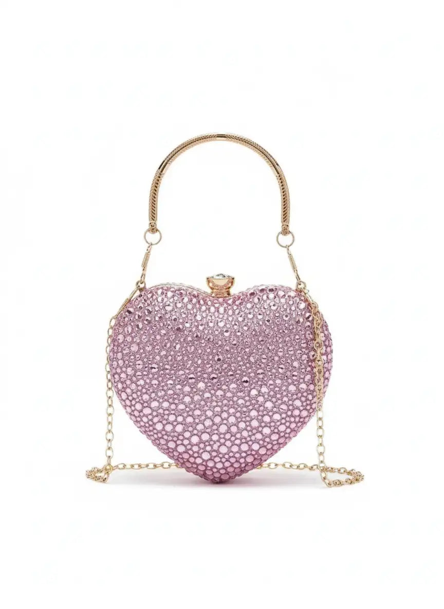 Pink heart-shaped clutch bag with gold chain on a white background