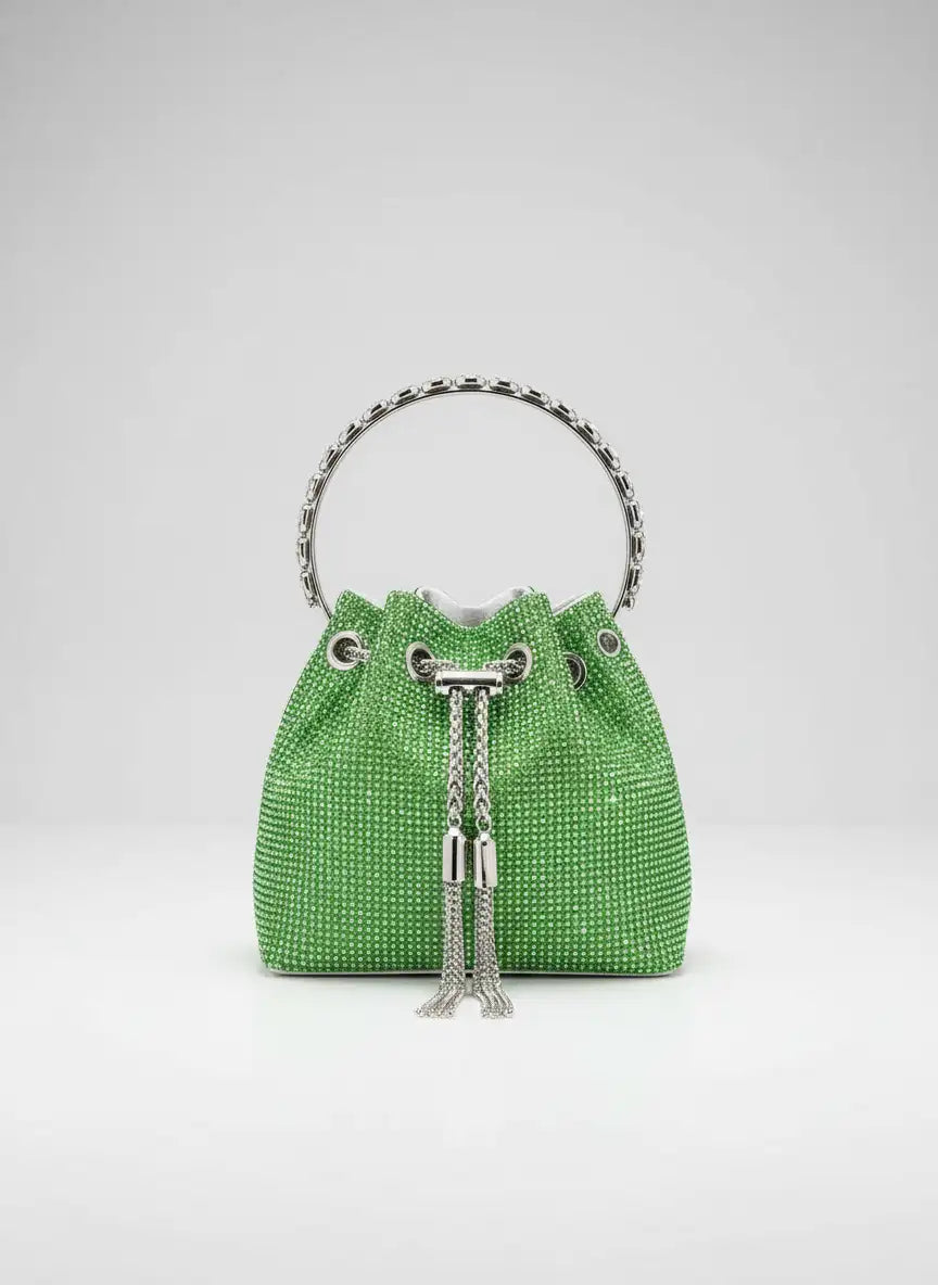 Green woven handbag with silver chain details on a light gray background
