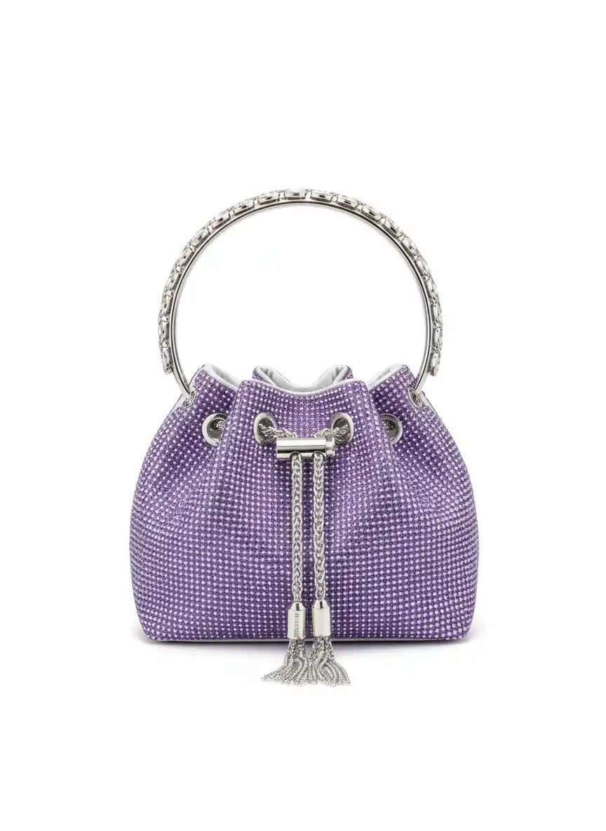 Purple handbag with silver chain and tassel on a white background