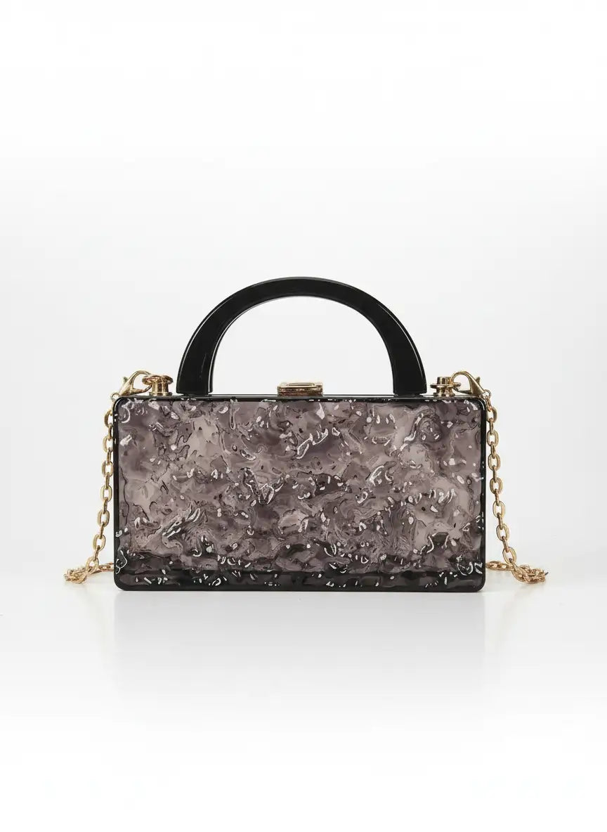 Black handbag with floral pattern on a white background